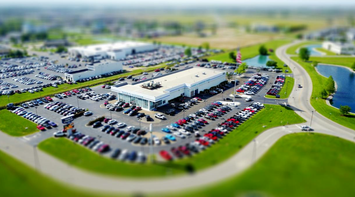 Parked cars neatly aligned in a city lot, demonstrating efficient use of urban parking space